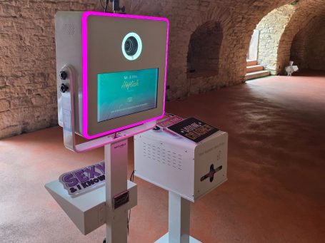 Fotobox Smilo Interaktive Informationsstation mit Bildschirm und Bedienfeld in historischer Umgebung.